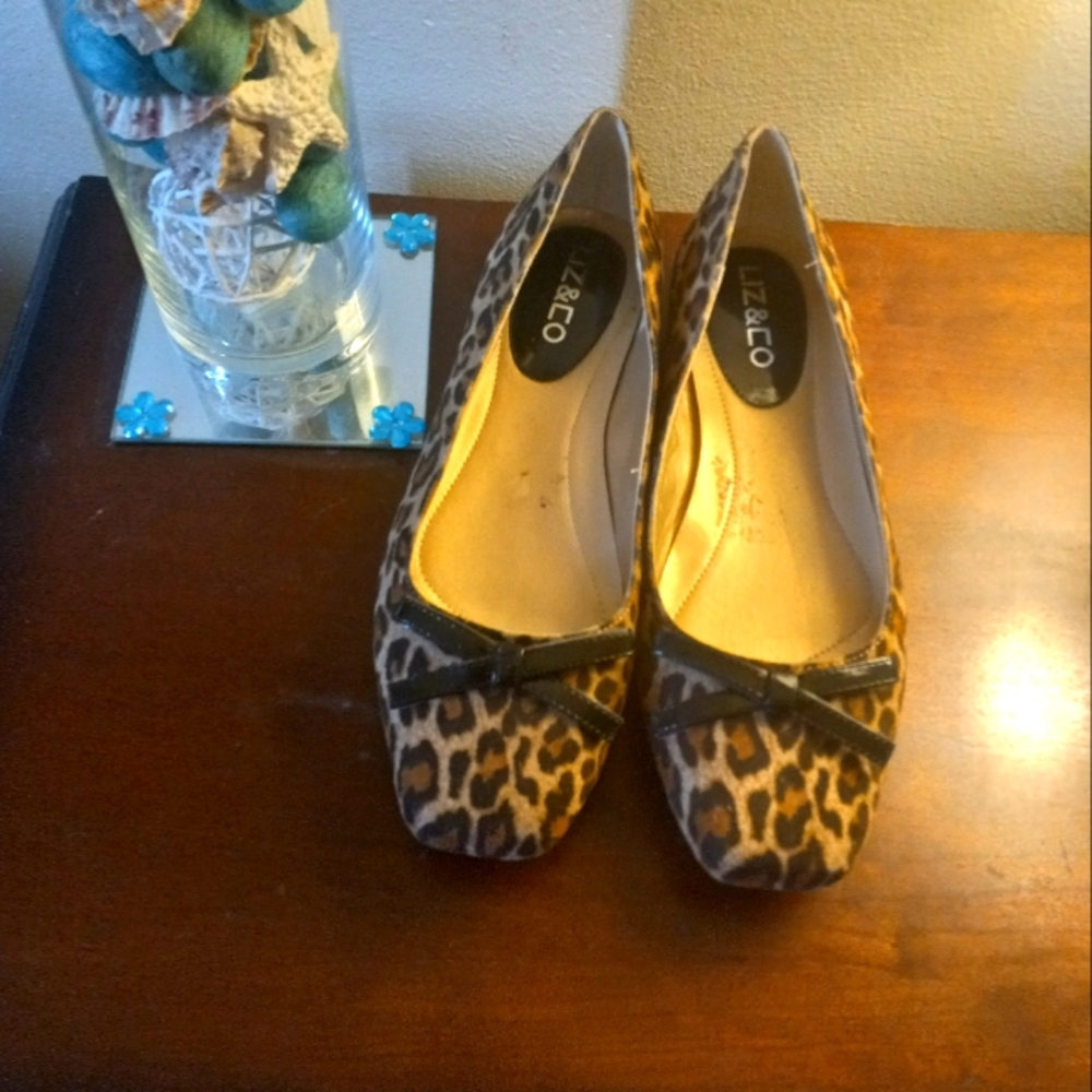 Size 8 1/2 man made, leopard look, low heeled pump with a thin bow at the top.